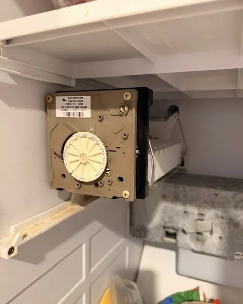 Refrigerator ice maker module mounted in the freezer compartment